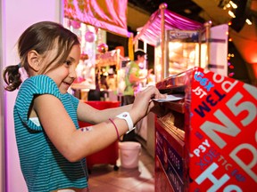 Hailey Lauzon mails her letter to Santa during the 2015 Festival of Trees at the Shaw Conference Centre in Edmonton on Saturday, Nov. 28, 2015. (Codie McLachlan/Edmonton Sun/Postmedia Network)