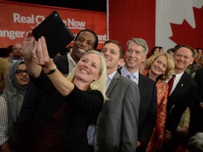 Newly-elected Liberals Catherine McKenna, left to right, Greg Fergus, Francis Drouin, Andrew Leslie, Karen McCrimmon and David McGuinty take part in a welcome rally for designate prime minister Justin Trudeau in Ottawa on Tuesday, October 20, 2015. THE CANADIAN PRESS/Sean Kilpatrick