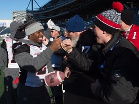 RedBlacks' Jovon Johnson greets fans during a team walk through in Winnipeg, Man. Saturday, Nov. 28, 2015. The Edmonton Eskimos will play the Ottawa RedBlacks in the 103rd Grey Cup Sunday. 
THE CANADIAN PRESS/Ryan Remiorz