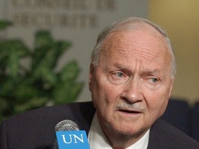 Canada's Maurice Strong, special advisor to United Nations Secretary General Kofi Annan on North Korea, strains to hear a question outside the Security Council at U.N. headquarters in New York, Wednesday, Jan. 22, 2003. The head of the U.N.'s environmental agency says Strong, whose work helped lead to the landmark climate summit that begins in Paris on Monday, Nov. 30, 2015, has died. He was 86. THE CANADIAN PRESS/Richard Drew