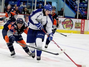 Flint Firebirds Mathieu Henderson battles for the puck with Sudbury Wolves Mikkel Aagaard during first period OHL action in Sudbury, Ont. on Saturday November 28, 2015. Gino Donato/Sudbury Star/Postmedia Network