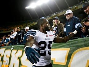 Former Argonaut and current Eskmo Patrick Watkins (25) celebrates  a Toronto win with a few Argo fans Argonauts at Commonwealth Stadium in Edmonton, Alta., on Saturday, Sept. 28, 2013. Codie McLachlan/Edmonton Sun/QMI Agency