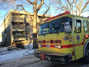 An Edmonton Fire Rescue Services truck is seen parked out front of a four-storey apartment complex near 115 Street and 107 Avenue after an early morning fire forced approximately 35 residents to evacuate the building. DAVID BLOOM/Edmonton Sun/ Postmedia Network