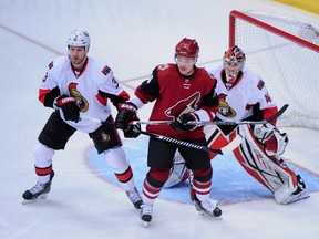 Arizona Coyotes center Max Domi (16) looks for the puck as Ottawa Senators defenceman Marc Methot (3) and goalie Craig Anderson (41) defend during the first period at Gila River Arena. Mandatory Credit: Matt Kartozian-USA TODAY Sports