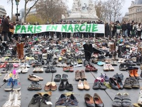 Barred from demonstrating, activists put down shoes as a way to show how many people would have marched on Sunday -- the day before the start of an international climate change conference in Paris. (VIVIAN SONG PHOTO)