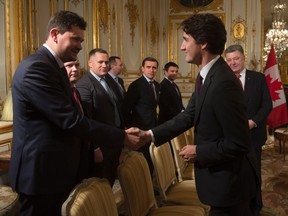 Ukrainian President Petro Poroshenko, left, introduces members of his delegation to Canadian Prime Minister Justin Trudeau at the start of a bilateral meeting before the United Nations climate change summit in Paris, France, on Sunday, Nov. 29, 2015. THE CANADIAN PRESS/Adrian Wyld