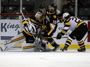 Kingston Frontenacs goalie Lucas Peressini feels the pressure from Sarina Sting's Patrick White during Ontario Hockey League action at the Rogers K-Rock Centre in Kingston, Ont. on Sunday November 29, 2015. The Frontenacs defeated the Sting 4-1. (Steph Crosier, Postmedia Network