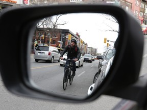 A cyclist rides on Bloor St. on Sunday. (CRAIG ROBERTSON, Toronto Sun)