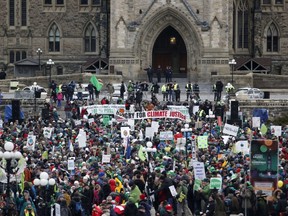 A large crowd gathers for The 100% Possible Climate March on Parliament Hill in Ottawa, Nov. 29, 2015. Some 150 leaders, including U.S. President Barack Obama, China's Xi Jinping, India's Narendra Modi and Russian President Vladimir Putin, will attend the start of the Paris conference, which is tasked with reaching the first truly universal climate pact, with the goal to limit average global warming to two degrees Celsius (3.6 degrees Fahrenheit), perhaps less, over pre-Industrial Revolution levels by curbing fossil fuel emissions blamed for climate change. (AFP PHOTO/PATRICK DOYLE)