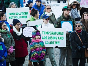 Marchers hold signs during the People's Climate March at the Alberta Legislature Building in Edmonton on Sunday. (Codie McLachlan/Edmonton Sun/Postmedia Network)