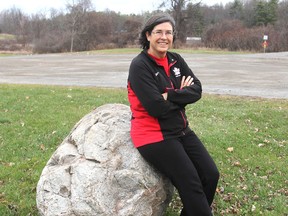 Former marathon swimmer Vicki Keith sits on a rock, now moved to Grass Creek Park in Kingston, Ont. on Friday, Nov. 27, 2015, that she touched at the end of one of her cross-lake swims. Michael Lea/The Whig-Standard/Postmedia Network