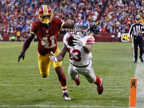 New York Giants wide receiver Odell Beckham (13) catches a touchdown pass as Washington Redskins cornerback Will Blackmon defends Sunday at FedEx Field. (Geoff Burke/USA TODAY Sports)