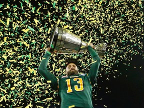Edmonton Eskimos quarterback Mike Reilly raises the Grey Cup after his team defeated the Ottawa Redblacks in the CFL's 103rd Grey Cup championship football game in Winnipeg, Manitoba, November 29, 2015.  REUTERS/Mark Blinch