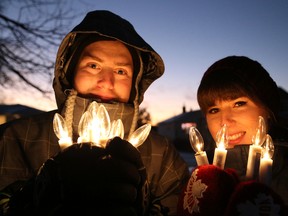 Mat Brode, left, and Ashley Gosselin hold artificial candles at a tree lighting ceremony in Capreol, Ont. on Saturday November 28, 2015. The festivities included a candle walk, carol singing, tree lighting, wagon rides, a visit by Santa Claus and Mrs. Claus, the Capreol Santa Claus Parade and fireworks. John Lappa/Sudbury Star/Postmedia Network