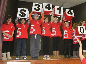 Youngsters hold up the final total raised during the United Way campaign touchdown breakfast in Kingston, Ont. on Monday, Nov. 30, 2015. The campaign reached its goal, taking in $3.4 million. Michael Lea/The Whig-Standard/Postmedia Network