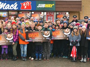 Between 85 and 90 students from Upper Thames Elementary School, representatives from Mac's convenience stores and the OPP, as well as local dignitaries attended the annual kickoff event for the province-wide Operation Heat program Nov. 26 in the Mac's convenience store parking lot in Mitchell. Operation Heat will see OPP officers handing out positive tickets to kids across the province who are seen doing good deeds in their communities. Each ticket doubles as a coupon for a free regular hot chocolate at any Mac's convenience store. GALEN SIMMONS/MITCHELL ADVOCATE