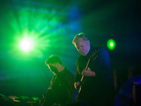 UK musicians Bernard Sumner and Phil Cunningham perform with their band New Order at the annual Clockenflap music festival in the Kowloon district of Hong Kong. (AFP/ANTHONY WALLACE)