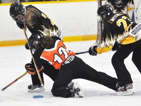 Mackenzie Wettlaufer (7) and Arly Mitchell of the Mitchell U19’s get twisted up with this Cambridge opponent during round robin action of the 32nd annual Mitchell Stingers ringette tournament last Friday, a 4-3 victory. The two teams met in the division final with the Stingers winning, 4-2. ANDY BADER/MITCHELL ADVOCATE