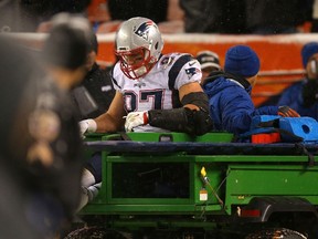 Tight end Rob Gronkowski of the Patriots is carted off of the field against the Broncos in the fourth quarter at Sports Authority Field at Mile High in Denver on Sunday, Nov. 29, 2015. (Justin Edmonds/Getty Images/AFP)