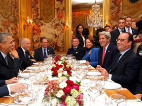 U.S. President Barack Obama, left, sits with French President Francois Hollande, right, during a dinner with U.S. Secretary of State John Kerry, second from right, French Minister for Ecology, Sustainable Development and Energy Segolene Royal, third from right, and French Foreign Minister, Laurent Fabius, second from left, at the Ambroisie restaurant in Paris, France, November 30, 2015. (REUTERS/Thibault Camus/Pool)