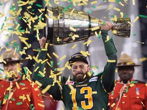 Edmonton Eskimos' quarterback Mike Reilly hoists the Grey Cup after his teams win over the Ottawa RedBlacks during the 103rd Grey Cup in Winnipeg, Man. Sunday, Nov. 29, 2015. THE CANADIAN PRESS/Ryan Remiorz