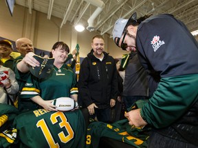 Edmonton Eskimos' Calvin McCarty signs fans as the team returns as Grey Cup 103 champions at Executive Flight Centre in Nisku, Alta., on Monday, November 30, 2015. The team will be celebrated in a street party at Churchill Square in Edmonton on December 1. Ian Kucerak/Edmonton Sun/Postmedia Network