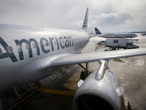 In this Feb. 26, 2014 file photo, an American Airlines Flight Airbus A319 is parked at a gate at Philadelphia International Airport as a US Airways plane taxis in the background, in Exton, Pa. (Alejandro A. Alvarez/Philadelphia Daily News via AP, File) T