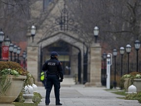 A member of the University of Chicago Police patrols the campus in Chicago, Illinois, United States, November 30, 2015. The University canceled Monday classes and activities after being warned by the FBI that someone had made an online threat of gun violence on campus, university President Robert J. Zimmer announced on Sunday.    REUTERS/Jim Young