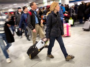 Holiday travellers walk through Penn Station in New York, November 26, 2014. Last week, the U.S. State Department issued a worldwide travel alert because of what it described as "increased terrorist threats." REUTERS/Brendan McDermid