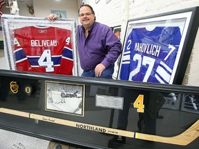 Jason Kaye, manager of Kaye's Auction House, displays some of the hockey memorabilia in his shop in Winnipeg, Man. Monday November 30, 2015 that will be auctioned off on Thursday.