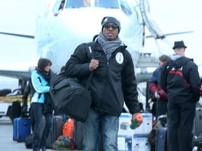 Ottawa RedBlacks quarterback Henry Burris walks from the team charter in Ottawa Monday. Nov. 30. after returning from the Grey Cup. The RedBlacks were defeated by Edmonton Sunday.  Tony Caldwell/Ottawa Sun/Postmedia Network