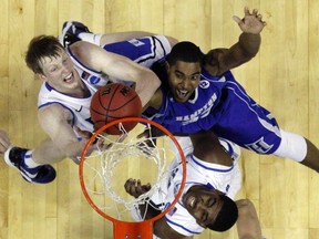 Forward Koron Reed, right, drafted in the first round Saturday by the London Lightning, battles Duke forward Kyle Singler for a rebound during an NCAA tournament game while with the Hampton Pirates. (Reuters)