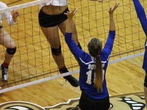 St. Mary's Flames middle hitter Kearley Abbott, who was named MVP of the Boston Pizza Manitoba High School 4A Girls' Volleyball Championship, spikes the ball against Selkirk Royals in the championship final, won 25-16, 25-12, 25-13 by St. Mary's on Monday, November 30, 2015. Photo by Rusty Barton.