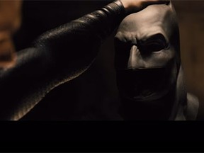 Henry Cavill holds Batman's mask after revealing Ben Affleck's Bruce Wayne in the trailer teaser for 'Batman v Superman: Dawn of Justice.' (YouTube screengrab)