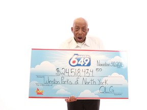 Winston Parks, 71, poses with his $24.5M Lotto 6/49 jackpot cheque. (Supplied photo)