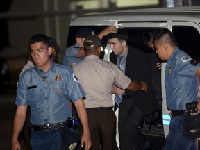 Philippine Bureau of Corrections personnel escort U.S. Marine Lance Corporal Joseph Scott Pemberton, second from right, after he was found guilty by trial court of killing Jennifer Laude, a transgender woman, upon arrival in a detention facility at Camp Aguinaldo in Quezon city, Metro Manila, December 1, 2015. REUTERS/Ted Aljibe/Pool