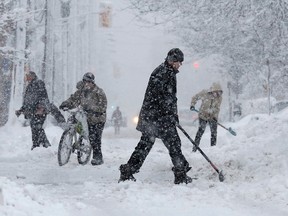 People clear snow during heavy snowfall in Ottawa, Ont., in this Feb. 27, 2013 file photo. (REUTERS/Chris Wattie)