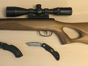 A pellet rifle and knives seized by Kingston Police during an arrest on Conacher Drive Tuesday morning. Kingston Police handout.