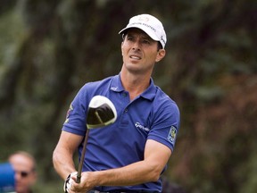 Mike Weir, from Bright's Grove, Ont., tees off during final round play at the Canadian Open golf championship Sunday, July 27, 2014 at Royal Montreal golf club in Montreal. Motivated by his daughters and fresh off a break from golf, Weir is ready to start his comeback. (THE CANADIAN PRESS/Ryan Remiorz)