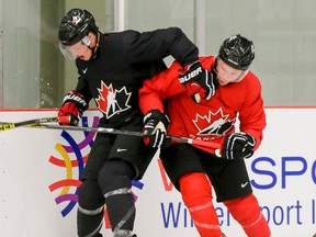 Jayce Hawryluk (right) collides with Thomas Chabot during Hockey Canada's National Teams' Summer Showcase at Winsport in Calgary, Alta., on Saturday, Aug. 1, 2015.