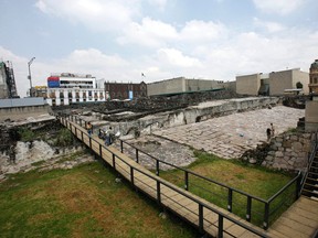 In this Oct. 3, 2006 photo, people visit the archaeological site, the Templo Mayor, in Mexico City. A Mexican archaeologist said Monday, Nov. 30, 2015, his team has discovered, at the archaeological site, a long tunnel leading into the center of a circular platform where Aztec rulers were believed to be cremated. The Aztecs are believed to have cremated the remains of their leaders during their 1325-1521 rule, but the final resting place of the cremains has never been found. (AP Photo/ Claudio Cruz, File)