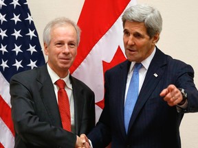 Foreign Minister Stephane Dion, left, meets with U.S. Secretary of State John Kerry alongside NATO ministerial meetings at NATO Headquarters in Brussels, Tuesday, Dec. 1, 2015. (Jonathan Ernst/Pool Photo via AP)