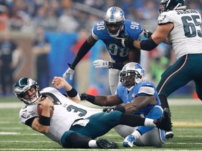 Detroit Lions middle linebacker Stephen Tulloch sacks Philadelphia Eagles quarterback Mark Sanchez during the third quarter of a NFL game on Thanksgiving at Ford Field. Lions win 45-14. (Raj Mehta/USA TODAY Sports)