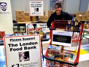Jane Roy, co-executive director of The London Food Bank, with a shopping cart of non-perishable goods during the launch of the Business Cares Food Drive in London Ont. Dec. 1, 2015. CHRIS MONTANINI\LONDONER\POSTMEDIA NETWORK
