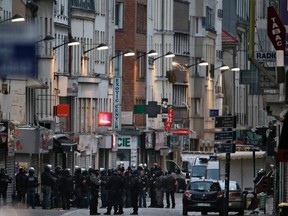 In this file picture taken on Nov. 18, 2015, police officers gather in the northern Paris suburb of Saint-Denis, as French Police special forces raid an apartment, hunting those behind the attacks that claimed 130 lives in the French capital. A person described as being "close" to Bendaoud Jawad, the man who provided lodgings in Saint-Denis to two perpetrators of the Paris attacks was arrested on Dec. 1, 2015, and placed in custody, police sources said. (AFP/KENZO TRIBOUILLARD)