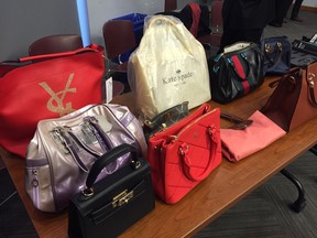 Counterfeit goods seized by Toronto cops in Project PACE II, including Kate Spade bags, Gucci wallets and Blue Jays jerseys, on display Tuesday, Dec. 1, 2015. (Maryam Shah/Toronto Sun)