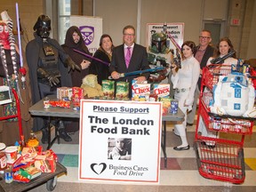 May the food be with you. Business Cares Food Drive chair Wayne Dunn (centre) and Mark Vaandering of the London Home Builders Association (right) pose with people dressed as Star Wars characters for the launch of the 16th annual food drive. (DEREK RUTTAN, The London Free Press)