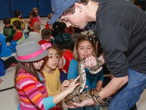 Students at Bayridge Public School get the chance to see a variety of salamanders and snakes, like this python, up close as part of the Reptile and Amphibian Advocacy project in Kingston. (Julia McKay/The Whig-Standard)