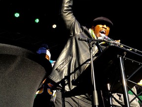 Eskimos GM Ed Hervey hoists the Grey Cup on stage during Tuesday's rally for the team at Churchill Square. (Perry Mah, Edmonton Sun)