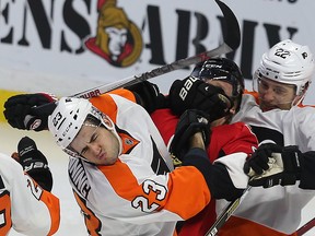 The Ottawa Senators took on the Philadelphia Flyers at Canadian Tire Centre in Ottawa Tuesday Dec. 1, 2015. Senators' Milan Michalek gets hit by Flyers Brandon Manning and Luke Schenn during second period action Tuesday. Tony Caldwell/Ottawa Sun/Postmedia Network